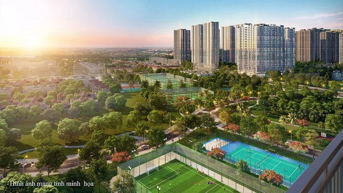 Toàn cảnh khu đô thị với các tòa nhà cao tầng, công viên cây xanh và sân thể thao dưới ánh hoàng hôn.